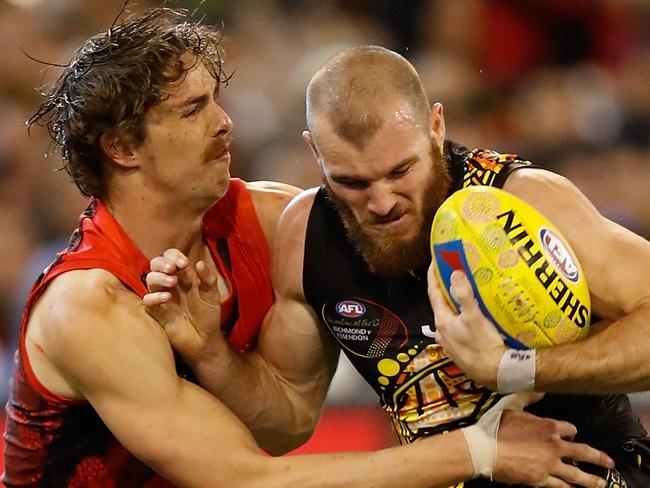 MELBOURNE, AUSTRALIA - MAY 27: Kamdyn McIntosh of the Tigers is tackled by Joe Daniher of the Bombers during the 2017 AFL round 10 Dreamtime at the G match between the Richmond Tigers and the Essendon Bombers at the Melbourne Cricket Ground on May 27, 2017 in Melbourne, Australia. (Photo by Michael Willson/AFL Media/Getty Images)