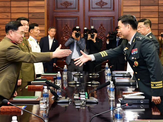 PANMUNJOM, NORTH KOREA - JUNE 14:  In this handout image provided by South Korean Defense Ministry, South Korean Major. Gen. Kim Do-gyun (R) shakes hands with his North Korean counterpart Lt. Gen. An Ik-san (L) during a meeting on June 14, 2018 in Panmunjom, North Korea. Two Koreas began their first high-level military talks in more than 10 years to discuss ways to ease cross-border tensions.  (Photo by South Korean Defense Ministry via Getty Images)