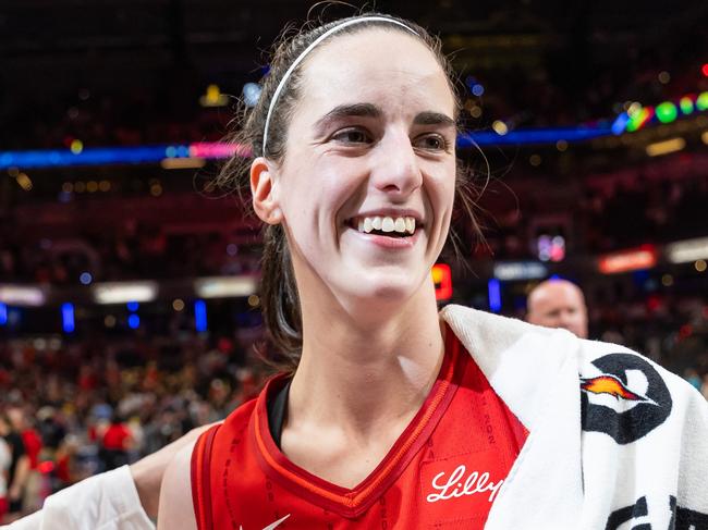 INDIANAPOLIS, INDIANA - JULY 6: Caitlin Clark #22 of the Indiana Fever is presented the game ball after becoming the first rookie to score a triple double against the New York Liberty at Gainbridge Fieldhouse on July 6, 2024 in Indianapolis, Indiana. NOTE TO USER: User expressly acknowledges and agrees that, by downloading and or using this photograph, User is consenting to the terms and conditions of the Getty Images License Agreement. (Photo by Michael Hickey/Getty Images)