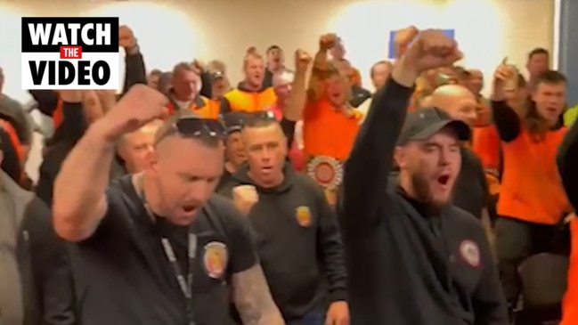 Union members chant at takeover meeting