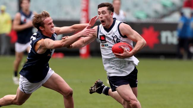 Lachlan Ash uses his speed to evade an opponent.