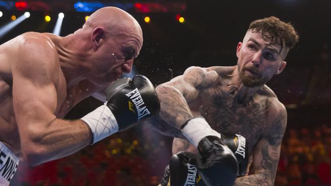 Jack Brubaker lays one on Danny Kennedy during their welterweight bout at the ICC Sydney Theatre. Picture: AAP Image/Craig Golding