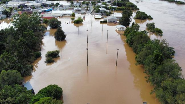 A tonne of Woolworths-donated fresh drinking water had to be delivered by helicopter to people displaced by the Gympie floods in Qld. Pictured are the netball courts, inundated by the Mary River on February 27. Picture: Facebook