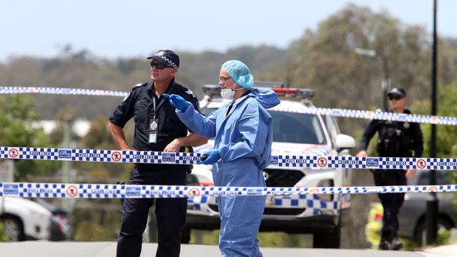 Police comb the crime scene outside the home where Shane Bowden was killed on the Gold Coast. Picture: Richard Gosling.