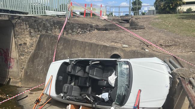 A man had to be cut free from his car which landed on its side in a water drain at Bundaberg Central.