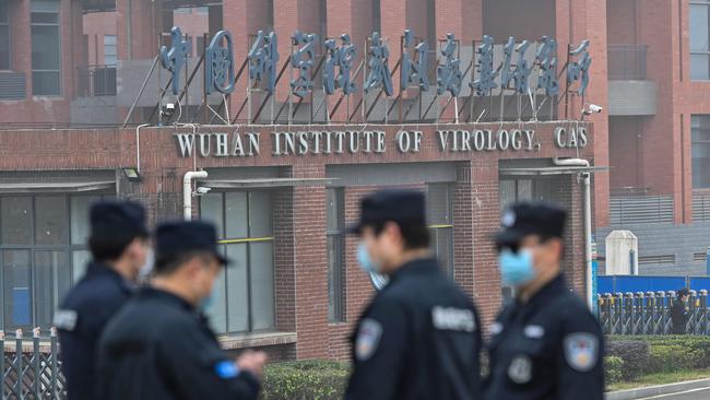 Security personnel stand guard outside the Wuhan Institute of Virology in Wuhan as members of the World Health Organization team investigating the origins of COVID-19 make a visit.