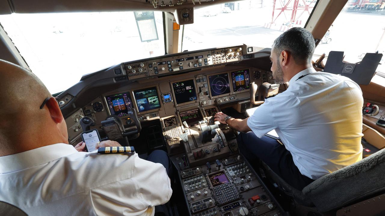 Pilots aboard an Emirates Boeing 777 ahead of a test flight using 100 per cent sustainable aviation fuel in one of the two engines. Picture: AFP