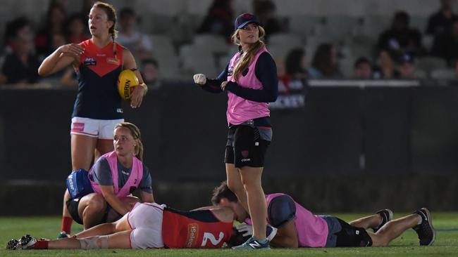 Melbourne’s Meg Downie is knocked out during a 2017 game. Picture: AAP