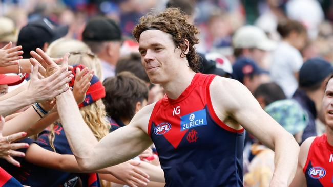 MELBOURNE, AUSTRALIA - MARCH 17: Ben Brown of the Demons celebrates a win with fans during the 2024 AFL Round 01 match between the Melbourne Demons and the Western Bulldogs at the Melbourne Cricket Ground on March 17, 2024 in Melbourne, Australia. (Photo by Dylan Burns/AFL Photos via Getty Images)