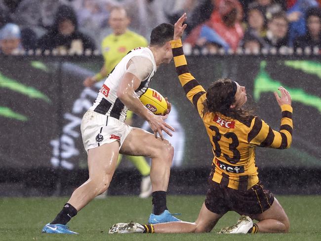 Jack Ginnivan feels the brunt of a high Brayden Maynard fend-off. Picture: Darrian Traynor/Getty Images.