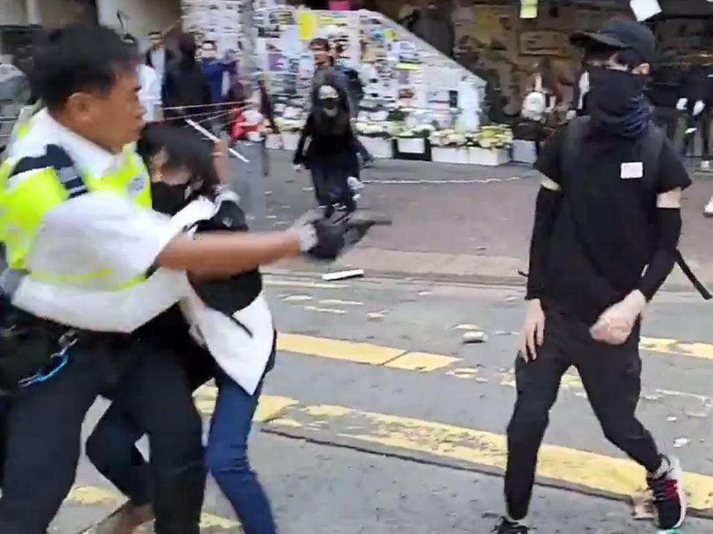 A video grab shows a police man pointing his gun at a pro-democracy protester during a protest in Sai Wan Ho district, in Hong Kong. Picture: AFP Photo/Cupid News