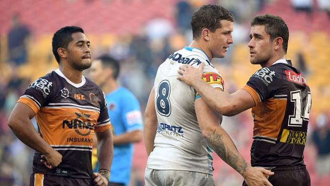 Wallace (centre) consoles former teammates Anthony Milford and Andrew McCullough after Gold Coast’s upset win over Brisbane. Picture: AAP Image/Dave Hunt