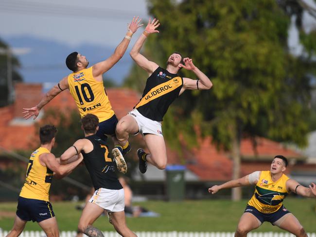 ANZAC DAY SANFL. Glenelg v Eagles at Woodville Oval on the 25th April, 2022. Eagles no 10 Connor Ballenden and Glenelg no 45 Nick Minchin go up for the ball. Picture: Tricia Watkinson