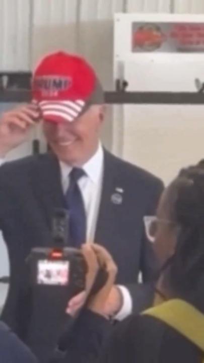 Biden seen sporting trump hat