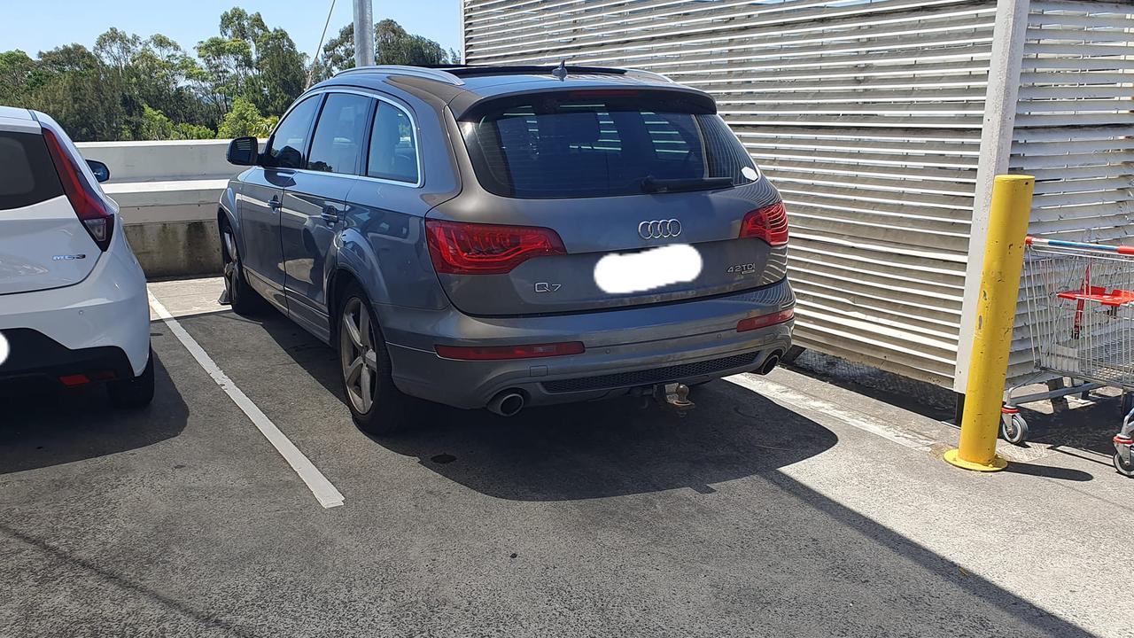 Adam parked his car as far over to the right side as possible. The white car pictured here has nothing to do with the parking dispute, as the person who presumably keyed his vehicle had already left by the time he took this photo.