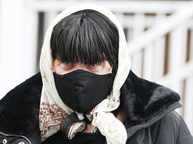 Reginald/ Regina Arthurell is removed from his Yagoona unit by a community corrections officer .picture John Grainger