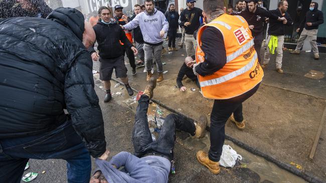 A man falls to the ground amid the chaos. Picture: David Geraghty