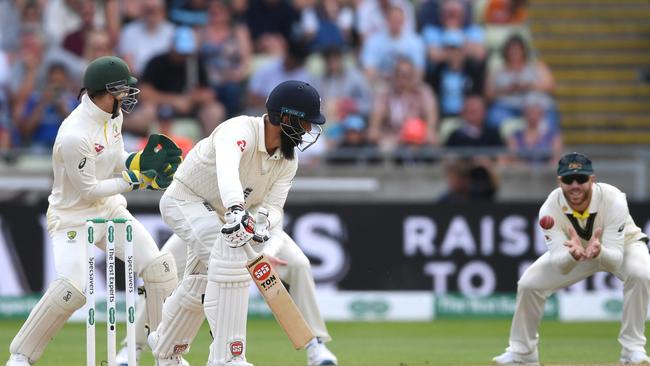 Nathan Lyon catches the edge of Moeen Ali’s bat with David Warner taking the catch. Picture: Gareth Copley/Getty Images