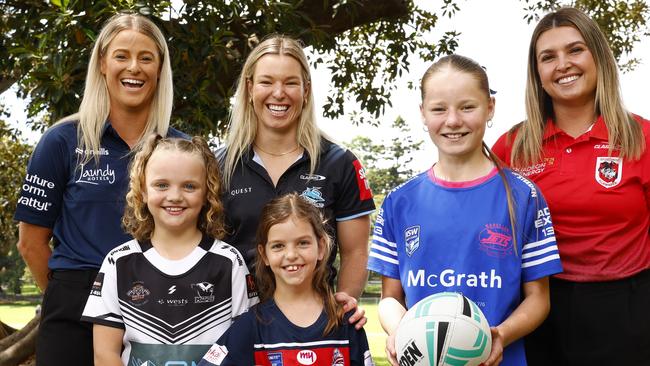 DAILY TELEGRAPH NOVEMBER 18, 2024. From left junior players Maddison Dolton, 9, Airlie Borg, 8, and Ella Brightwell, 12, with Bulldogs inaugural signing Tayla Preston, Sharks Emma Verran and Newcastle born Dragons player Bobbi Law during the announcement at the Domain Sydney, of the inaugural NRLW Magic round in Newcastle next season. Picture: Jonathan Ng