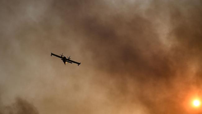 A Canadair firefighting airplane flies during a fire in Gennadi, on the southern part of the Greek island of Rhodes. Picture: AFP