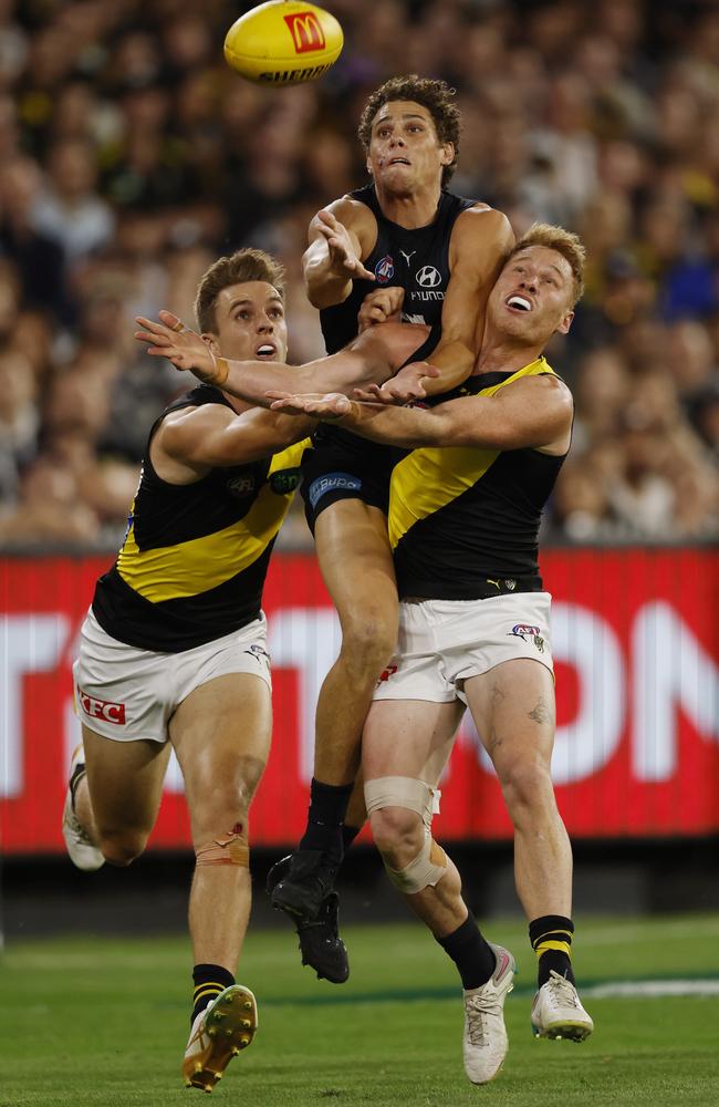 Tylar Young and Nick Vlastuin compete with star Blue Charlie Curnow at the MCG. Picture: Michael Klein