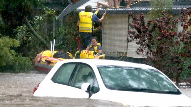 Paul and Debbie Edwards being rescued from their house at Ashgrove Ave. Picture: Steve Pohlner