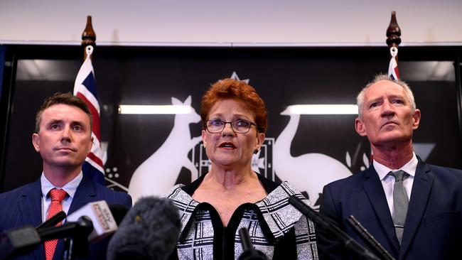 Queensland Senator and One Nation leader Pauline Hanson (centre), flanked by party officials James Ashby (left) and Steve Dickson, speaks during a press conference in Brisbane, Thursday, March 28, 2019. Mr Ashby and Mr Dickson were caught in an al-Jazeera investigation which used hidden cameras and a journalist posing as a gun campaigner to expose the far-right party's extraordinary efforts to obtain funding in Washington DC in September. (AAP Image/Dan Peled) NO ARCHIVING