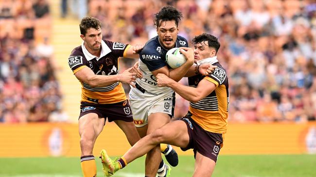 Jeremiah Nanai of the Cowboys (C) is tackled by Herbie Farnworth (R) and Corey Oates of the Broncos of the Broncos during the round three NRL match between the Brisbane Broncos and the North Queensland Cowboys at Suncorp Stadium, on March 27, 2022, in Brisbane, Australia. (Photo by Dan Peled/Getty Images)