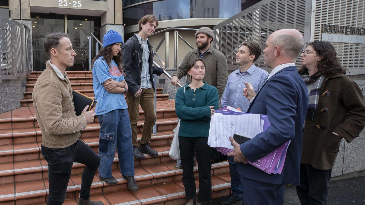 Bob Brown Foundation Tarkine campaigner Scott Jordan with Sakura Woods, Jimmy Cordwell, Darcy Wright, Ellen Maddock, Potto, Harrison Vermont and Tzigane Scholz- Talbot and lawyer Richard Griggs outside the Hobart Magistrates Court. Picture: Chris Kidd