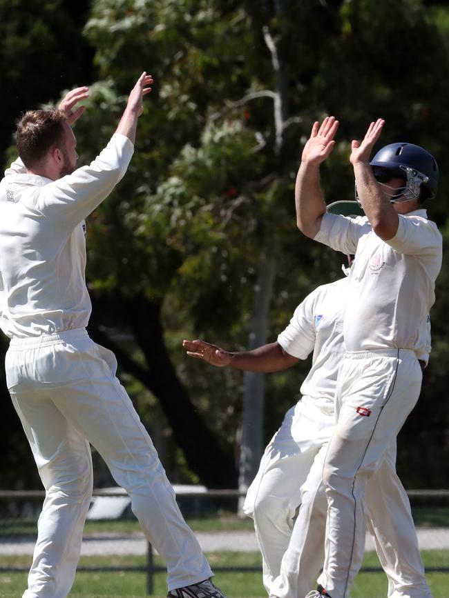 Mitchell Shellie and Stuart Rudge celebrate a wicket.