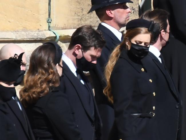 WINDSOR, ENGLAND - APRIL 17: Zara Tindall, Mike Tindall, Princess Eugenie, Jack Brooksbank, Princess Beatrice,  Edoardo Mapelli Mozzi, Catherine, Duchess of Cambridge and Camilla, Duchess of Cornwall stand outside St George's Chapel for the funeral service of Britain's Prince Philip, Duke of Edinburgh in Windsor Castle on April 17, 2021 in Windsor, United Kingdom. Prince Philip of Greece and Denmark was born 10 June 1921, in Greece. He served in the British Royal Navy and fought in WWII. He married the then Princess Elizabeth on 20 November 1947 and was created Duke of Edinburgh, Earl of Merioneth, and Baron Greenwich by King VI. He served as Prince Consort to Queen Elizabeth II until his death on April 9 2021, months short of his 100th birthday. His funeral takes place today at Windsor Castle with only 30 guests invited due to Coronavirus pandemic restrictions. (Photo by Jeremy Selwyn-WPA Pool/Getty Images)