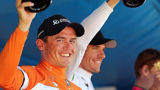 Simon Gerrans of Orica GreenEDGE celebrates on stage.