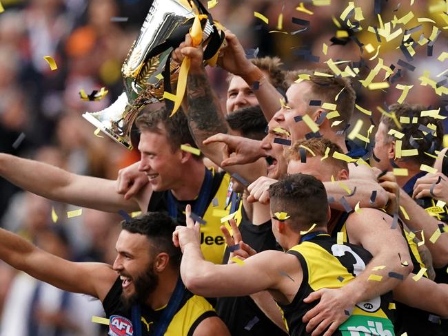 Richmond players react after receiving Australian Football League 2019 Premiership Cup after winning the  2019 AFL Grand Final between the Richmond Tigers and the GWS Giants at the MCG in Melbourne, Saturday, September 28, 2019. (AAP Image/Michael Dodge) NO ARCHIVING, EDITORIAL USE ONLY