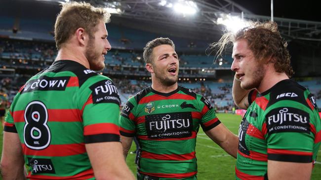 Souths’ Sam Burgess with his brothers Tom and George after victory against St George-Illawarra on Saturday. Picture: Brett Costello