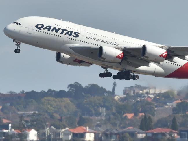 FILES-- This file photo taken on August 25, 2017 shows a Qantas Airbus A380 takes off from the airport in Sydney. Qantas Airways posted a bumper 17.9 percent jump in interim net profit to 473 million USD on February 22, 2018 and announced a share buyback with a strong result in its domestic arm boosting the bottom line. / AFP PHOTO / Peter PARKS