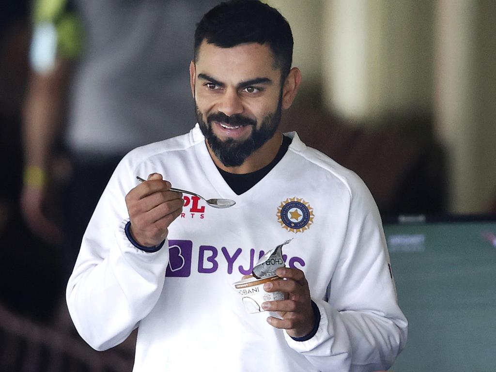 Kohli tucks into some yoghurt after an early morning jog.