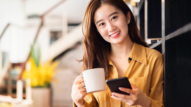 Cheerful Asian businesswoman in office.