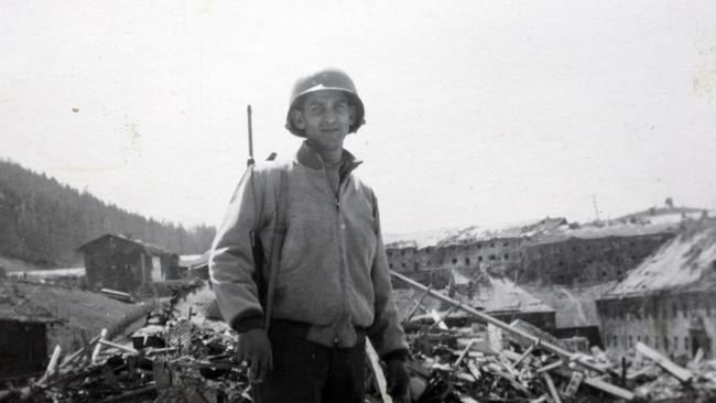 US Army Officer John Barsaian standing in front of the ruins of Berchtesgaden in May 1945.