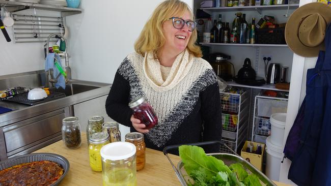 Sharon holds out some of their pickled veggies. To her left is a kale quiche. Picture: Alex Turner-Cohen