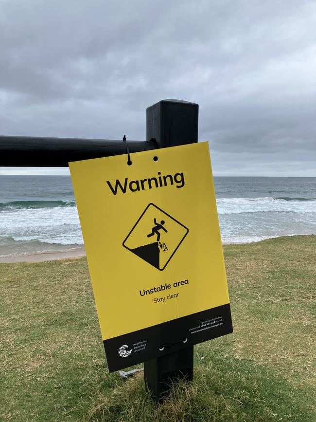 A warning sign near the Collaroy seawall. Picture: Heath Parkes-Hupton