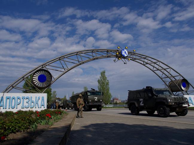 Russian military vehicles drive through the gates of the Zaporizhzhia Nuclear Power Station. Kyiv has called for the establishment of a demilitarised zone around the plant. Picture: AFP