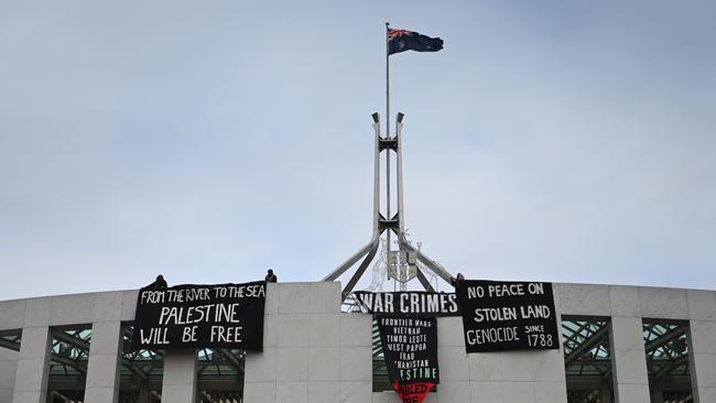Pro-Palestine jumped over barricades to access the roof of Parliament House. Picture: NewsWire/ Martin Ollman