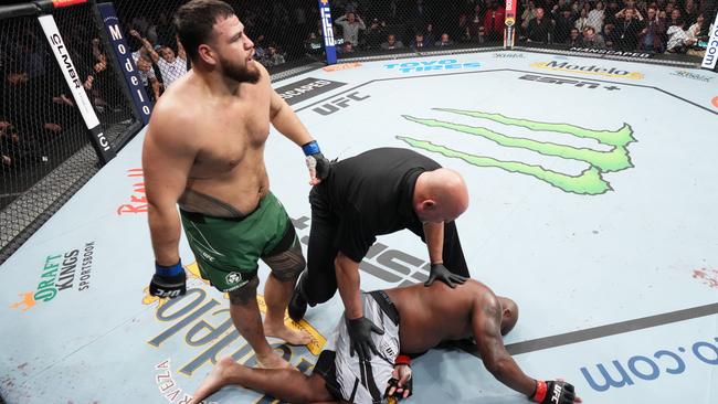 HOUSTON, TEXAS – FEBRUARY 12: (L-R) Tai Tuivasa of Australia walks off after knocking out Derrick Lewis in their heavyweight fight during the UFC 271 event at Toyota Center on February 12, 2022 in Houston, Texas. (Photo by Josh Hedges/Zuffa LLC)