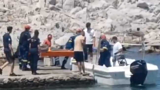 The body believed to be Dr Michael Mosley is carried 80ft from the rocks in Symi where he was found to the sea was seeking to reach. Picture: X