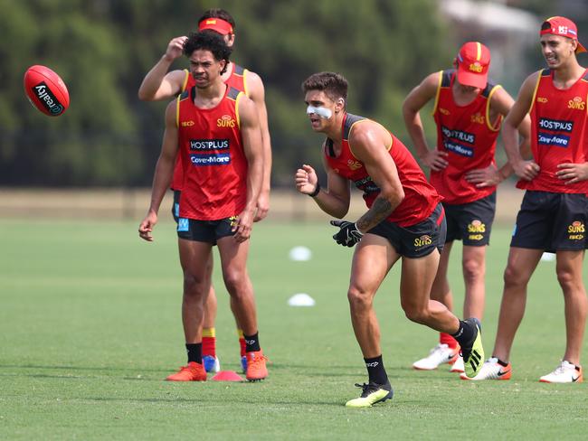 Sean Lemmens handballs during a Gold Coast Suns AFL training session at Metricon Stadium on December 09, 2019 in Gold Coast, Australia. (Photo by Chris Hyde/AFL Photos/Getty Images)