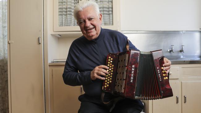 Henry Palaszczuk with his dad's squeeze box out side his old home at Inala. Picture: Mark Cranitch.