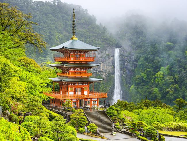 ESCAPE: NARA, JAPAN BY GEORGIE SAFE.  Nachi, Japan - April 21, 2014: Seiganto-ji Pagoda and Nachi no Taki waterfall.