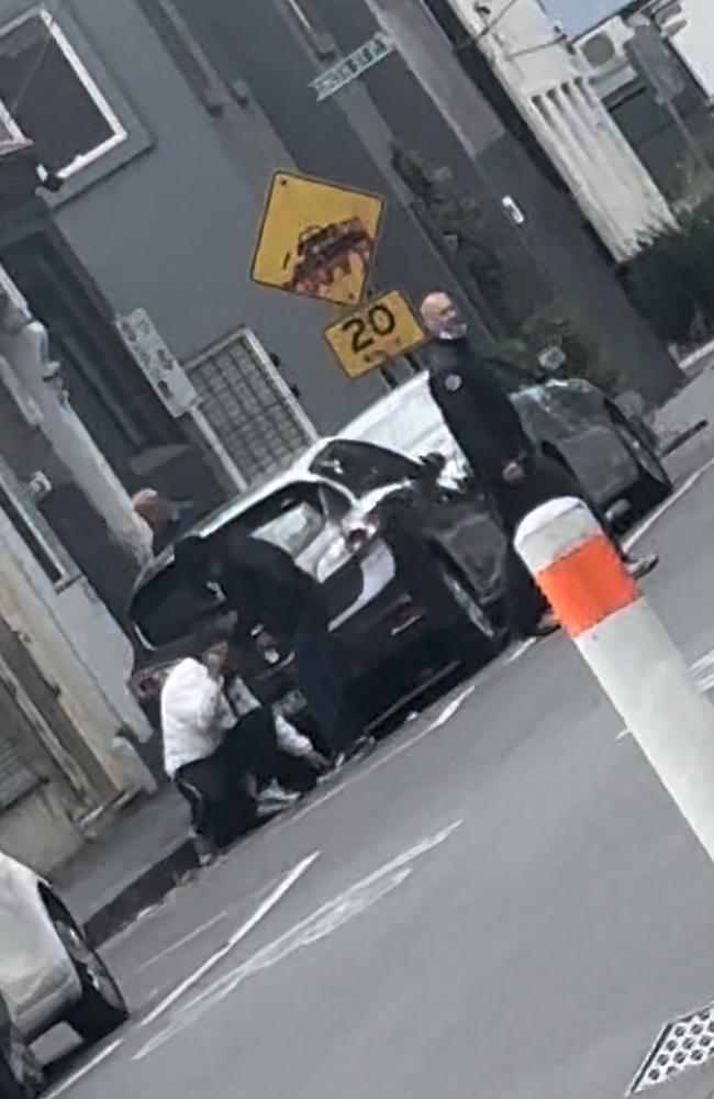 A man drifts in and out of consciousness near the safe injecting room in North Richmond. Picture: news.com.au