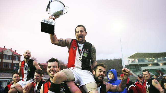 Luke Joseph, left, and Roger Belcher were chaired off after the ground after the SFL grand final between New Norfolk and Lindisfarne at North Hobart Oval. Picture: SAM ROSEWARNE