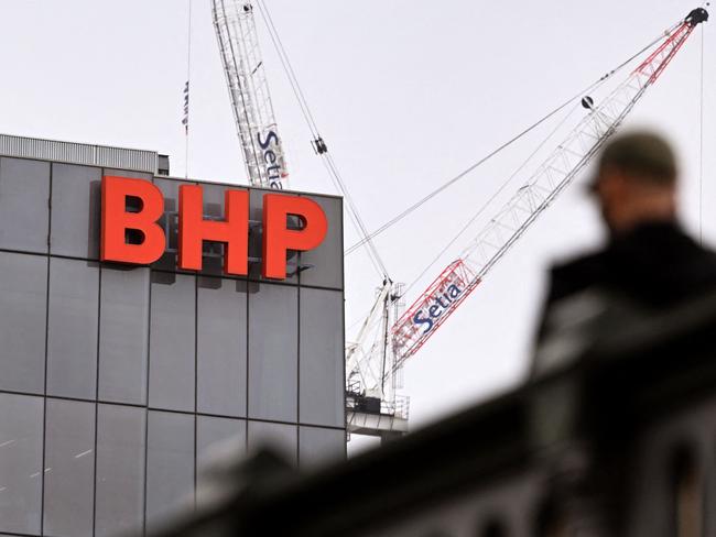 This file photo taken on February 21, 2023 shows the company logo adorning the side of the BHP global headquarters in Melbourne. Mining giant BHP reported an 86 percent slump in half-year net profit on February 20, 2024, hit by a write-down of its nickel assets and costs related to a 2015 Brazilian mining disaster. (Photo by William WEST / AFP)